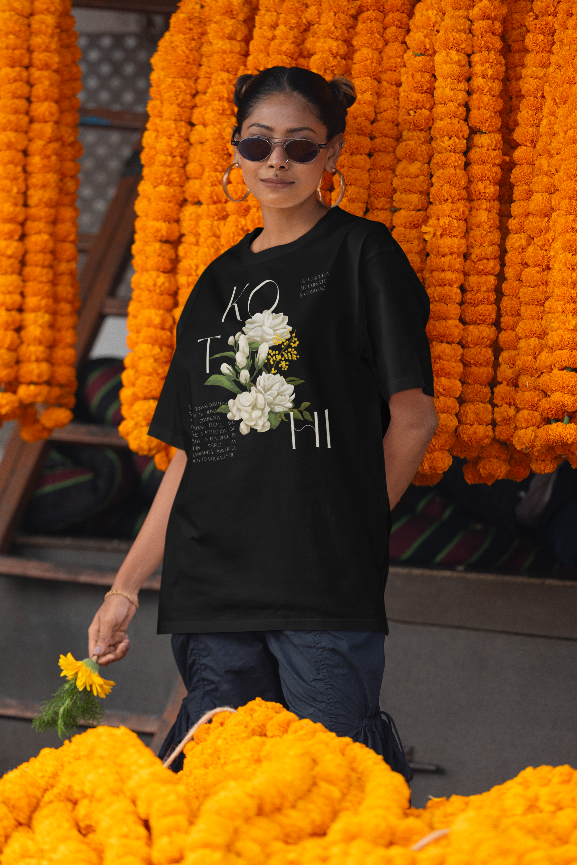 Desi Woman with oversized black tee with Kothi and flower design for AAPI Pride, Gay Pride and Trans Pride