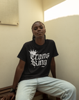 Camiseta gráfica Trans King con corona y gotas de pintura en aerosol sobre hombros caídos de gran tamaño en negro - 190 g/m²