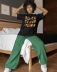 Black Trans & Proud T-Shirt African Culture Colors on Black Oversize Deep Drop Shoulder Tee Oversize Deep Drop Shoulder Tee - 190 GSM