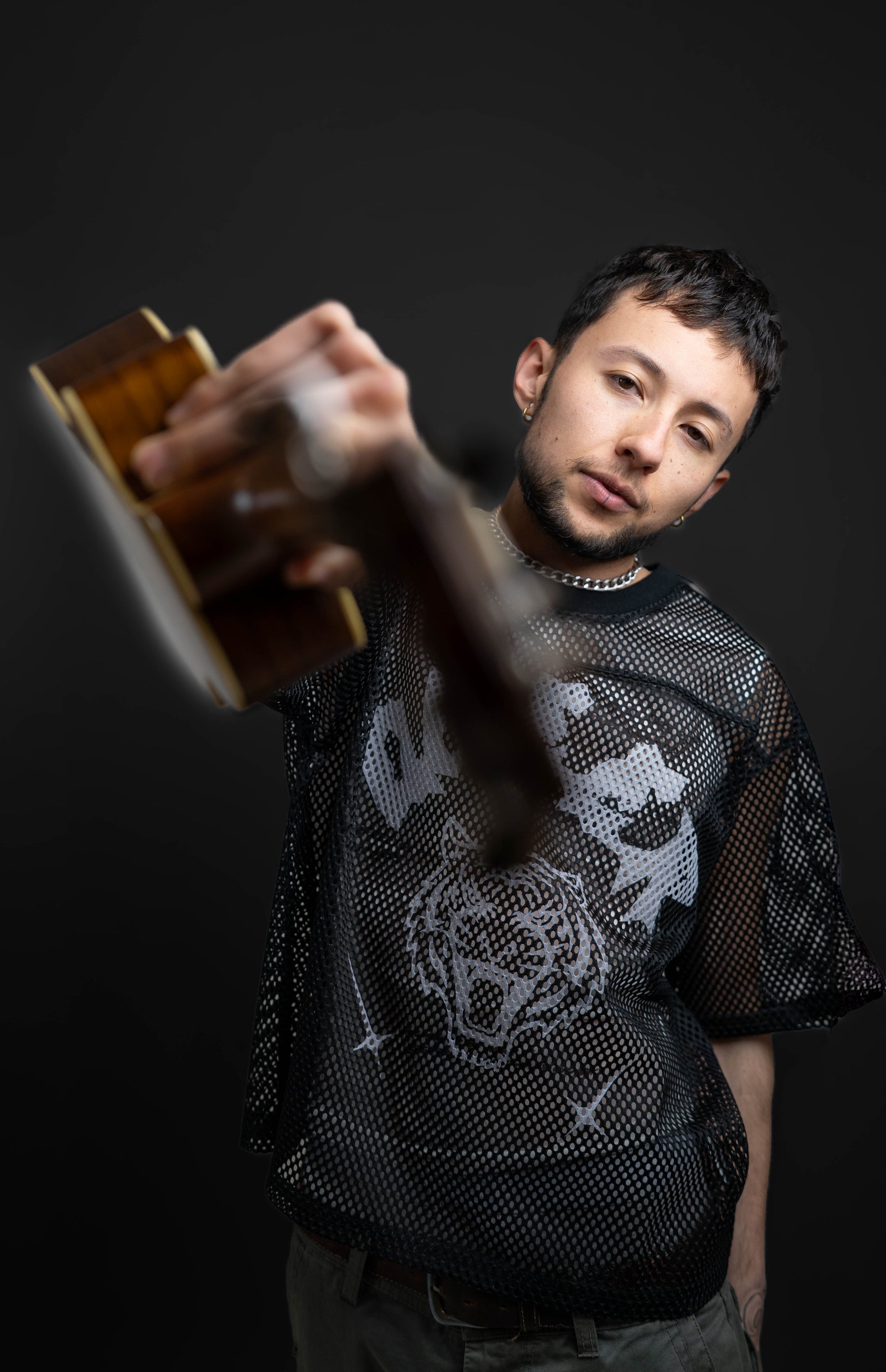 Pride Clothing Smiling Black Man with Black T-Shirt that says Nature is Queer with Sketch graphics of queer animals and plants 