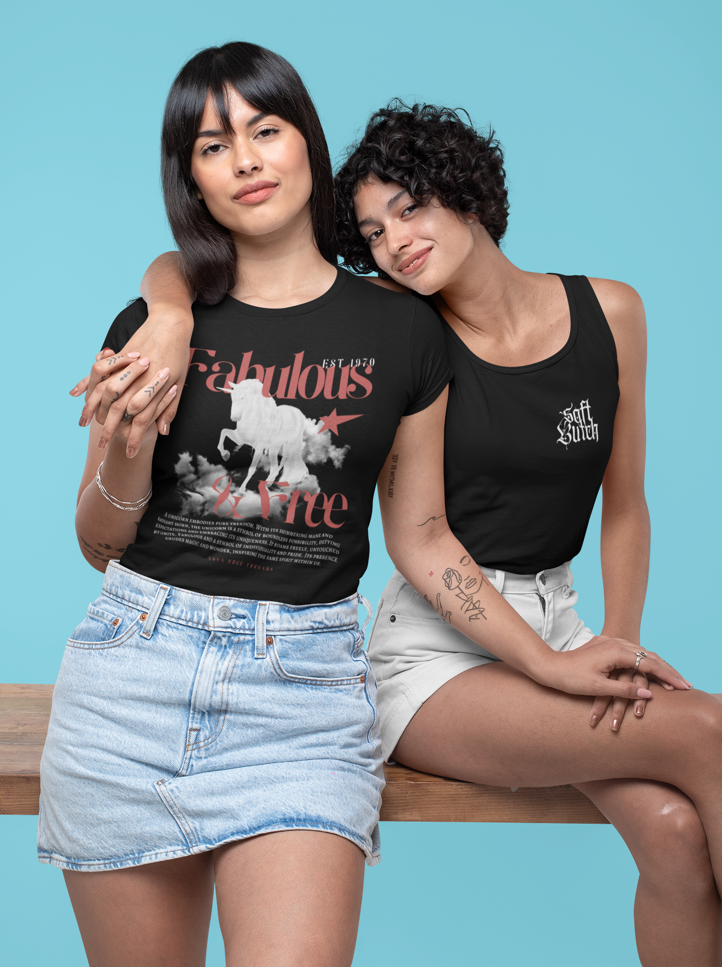 Two hispanic women holding hands one with black pride shirt that says Fabulous & Free with Unicorn and other black pride tank top that says soft butch for lesbian couple pride shirts