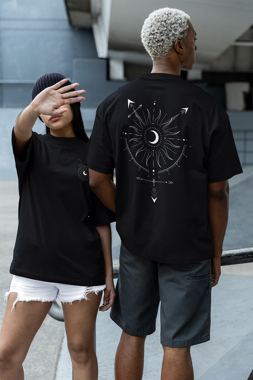 Two people wearing black oversize tees with one that has a Celestial Design Taro Card Inspired full back design for Queer Pride LGBTQIA+ Pride Tee