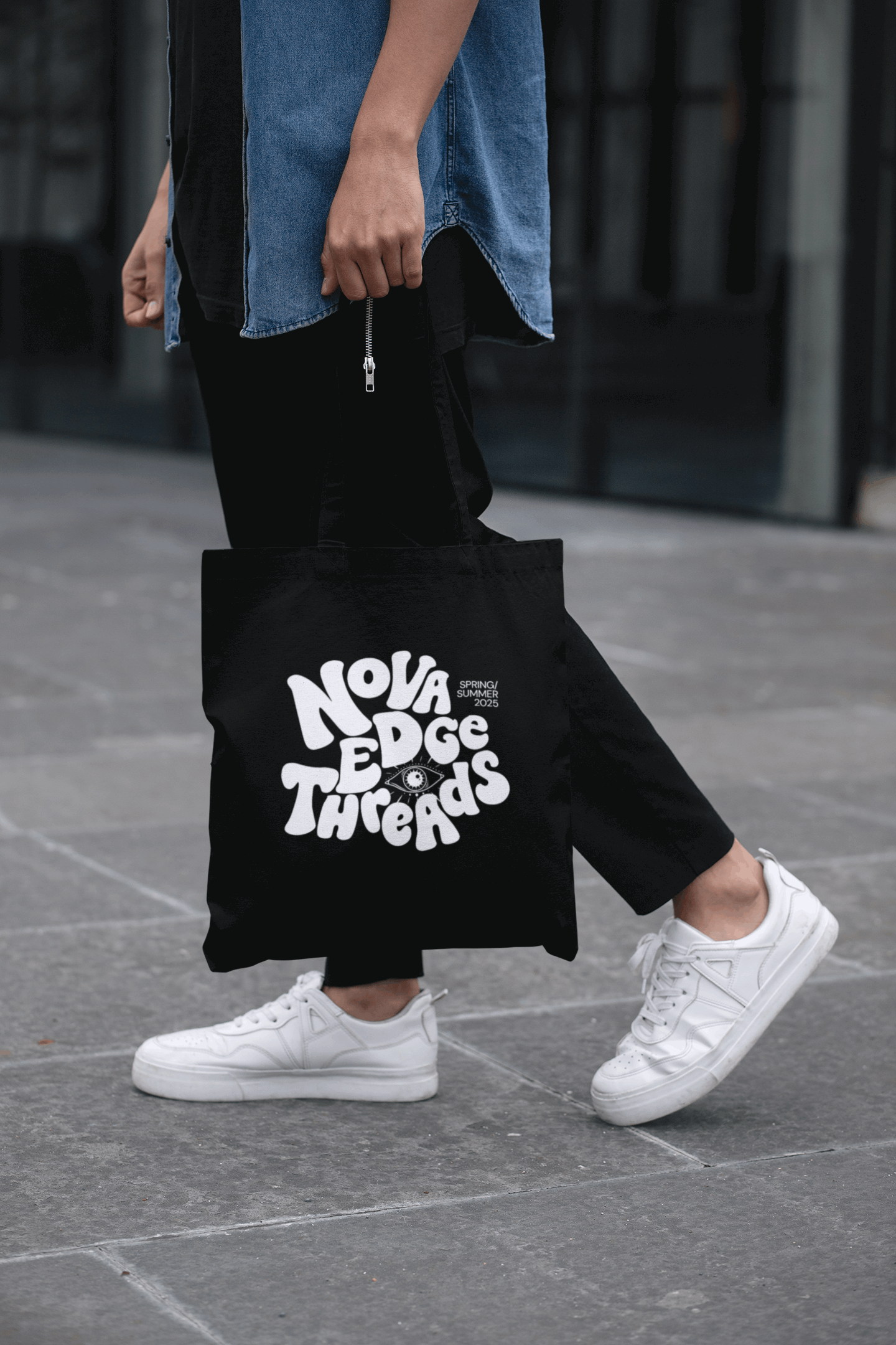 Hispanic Man walking with denim shirt and black pants with a Black carrying bag with Nova Edge Threads Nostalgic Font