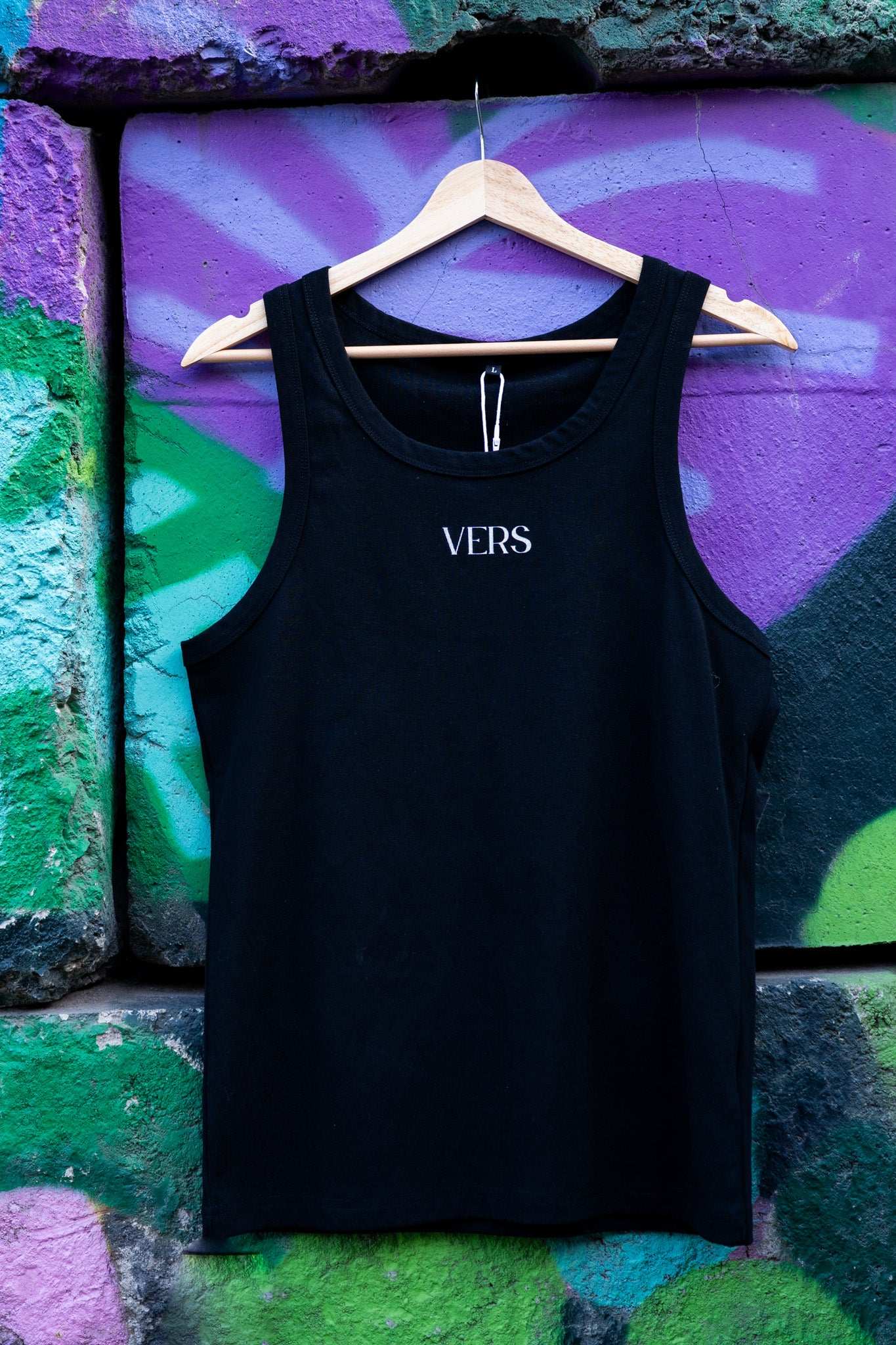 VERS Pride Tank Minimal on front of Black High Performance Tank Top High Performance Tank Top