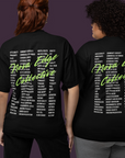 Two people wearing Nova Edge Collective shirts that are black with white text for the banned words list and neon green cursive for NE Collective